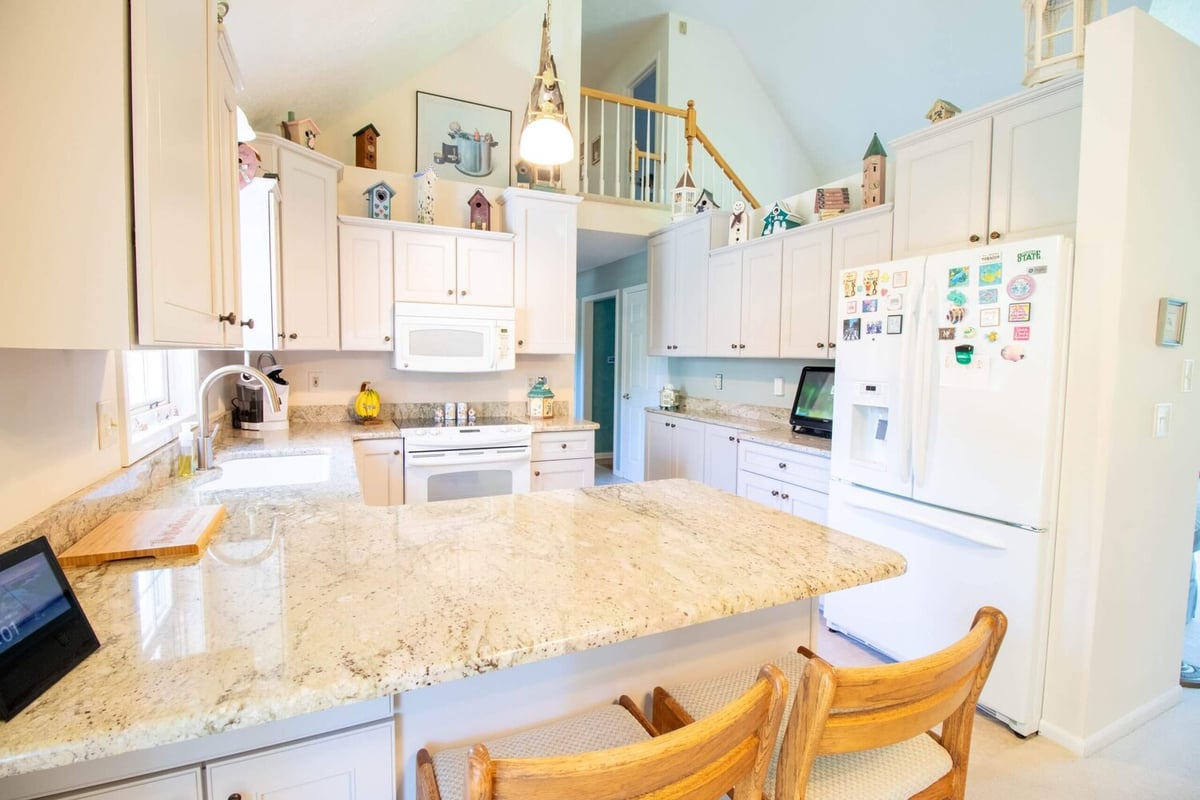 kitchen remodel by Odd Fellows Contracting in Williamston, MI showcasing granite countertops and tall cabinets