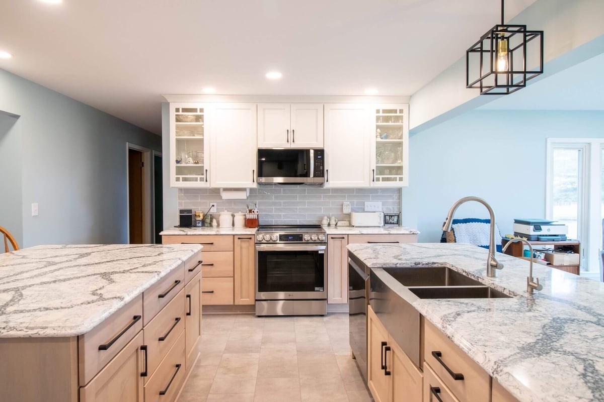 full kitchen view after remodel by Odd Fellows Contracting in Owosso, MI with white cabinetry and large island