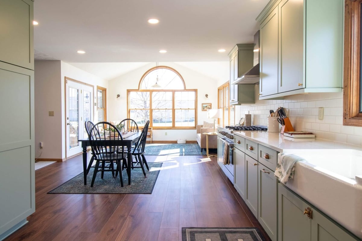 remodeled kitchen in Holt Four Seasons, MI by Odd Fellows Contracting with sage green cabinets and white countertops