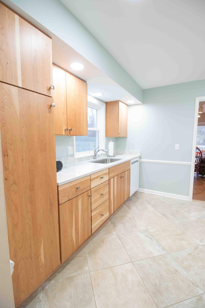 Kitchen remodel with custom cabinetry and sink area by Odd Fellows Contracting in Lansing, MI