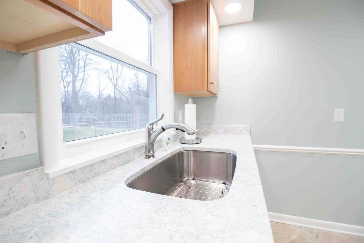 Kitchen remodel with stainless steel sink and updated countertops by Odd Fellows Contracting in Lansing, MI