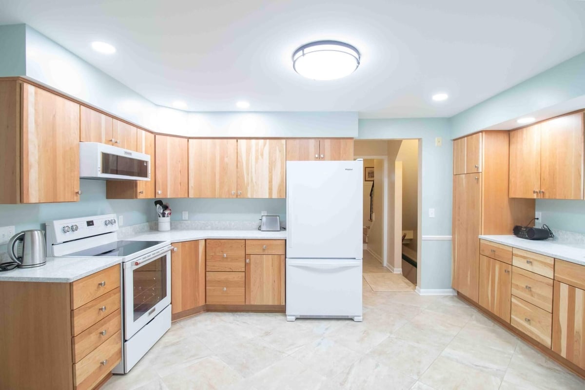 Open kitchen remodel with custom wood cabinets by Odd Fellows Contracting in Lansing, MI