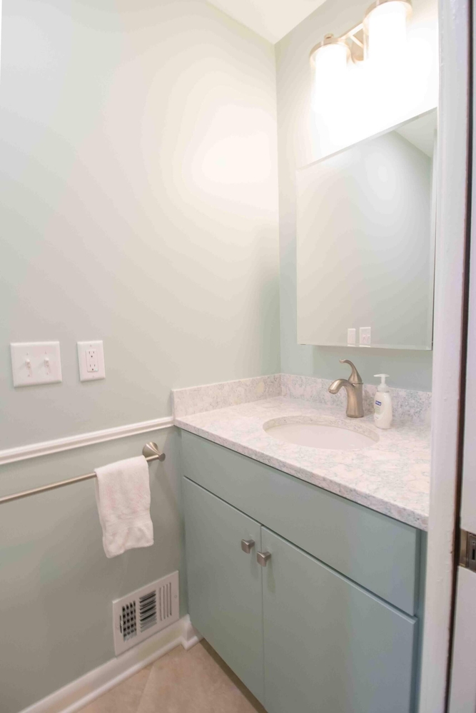 Powder room remodel with new vanity and countertop by Odd Fellows Contracting in Lansing, MI