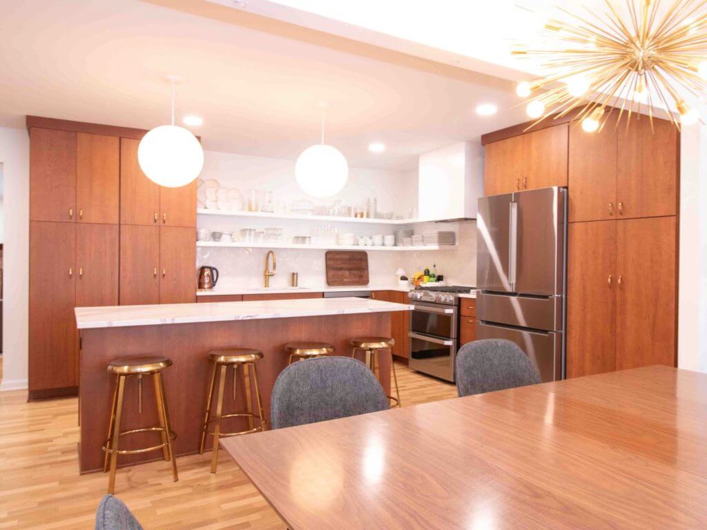 East Lansing, MI kitchen remodel by Odd Fellows Contracting featuring custom wood cabinets and modern lighting