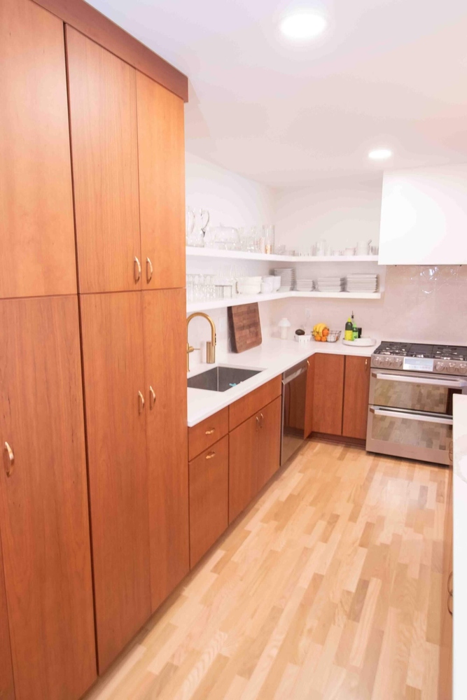 modern galley kitchen remodel by Odd Fellows Contracting in East Lansing, MI with custom wood cabinetry and open shelving