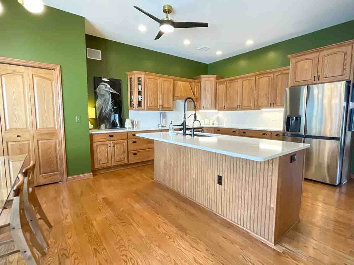 remodel featuring island seating and stainless steel appliances by Odd Fellows Contracting in Dewitt MI