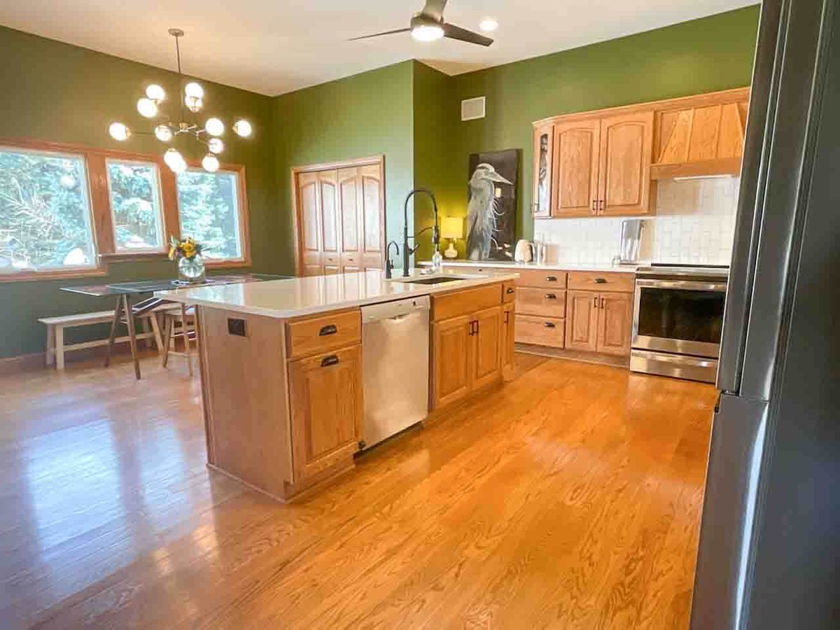 remodeled kitchen with large island and wood cabinetry by Odd Fellows Contracting in Dewitt MI