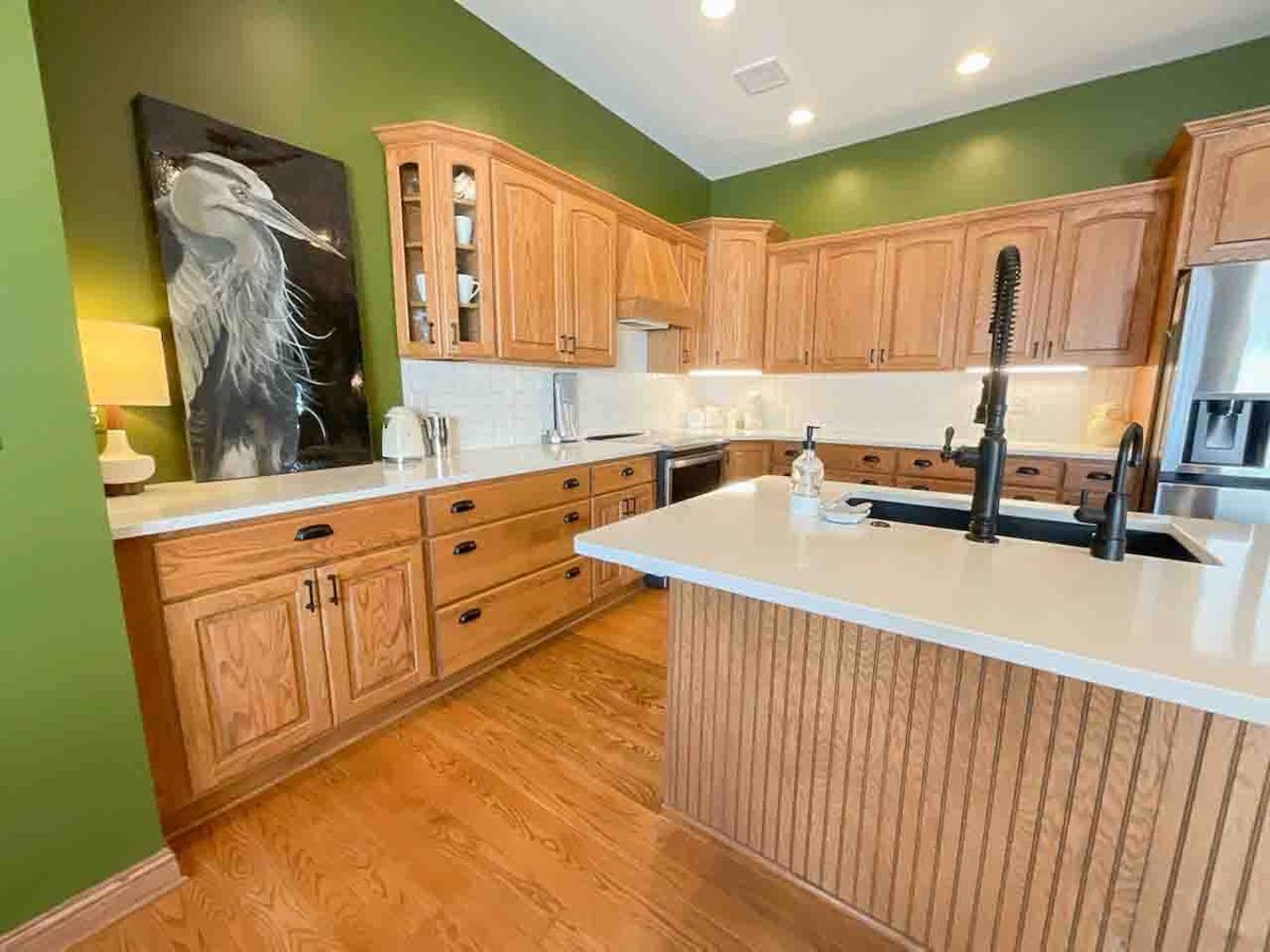 updated kitchen design with wood cabinets and island seating by Odd Fellows Contracting in Dewitt MI