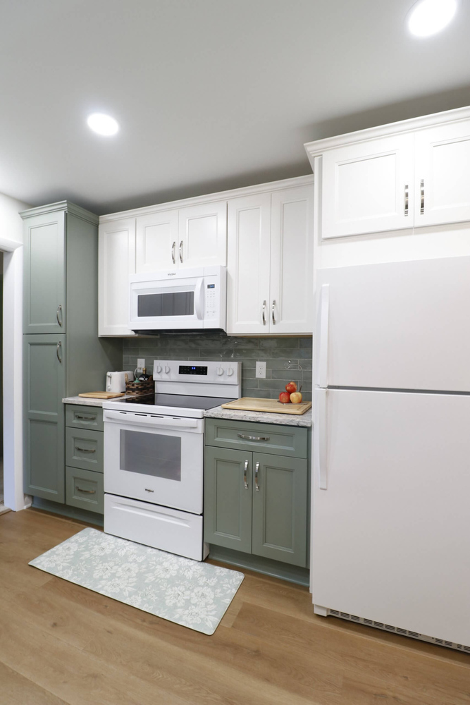 Tacoma Hills, MI kitchen remodel by Odd Fellows Contracting featuring modern white appliances and cabinetry