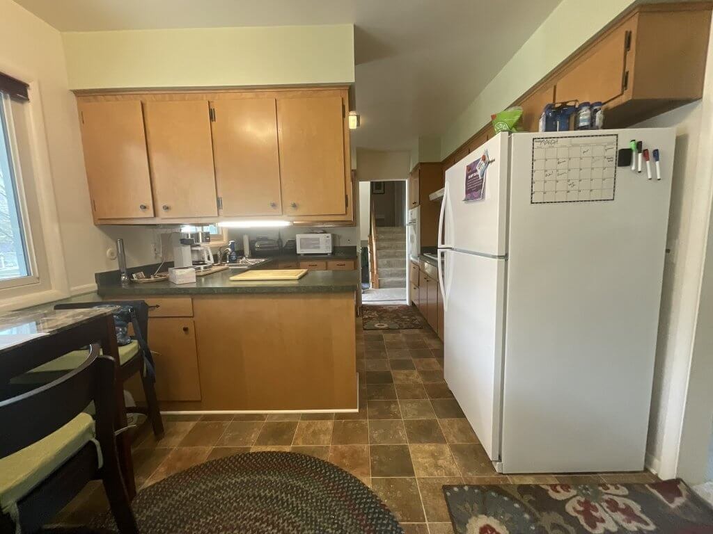 pre-renovation kitchen in Tacoma Hills, MI by Odd Fellows Contracting showing dated cabinetry and layout