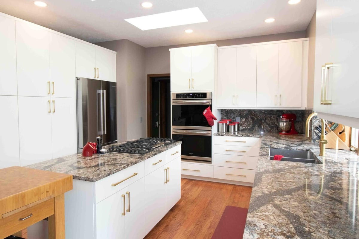 updated kitchen design with granite backsplash and custom cabinets by Odd Fellows Contracting in Lansing MI
