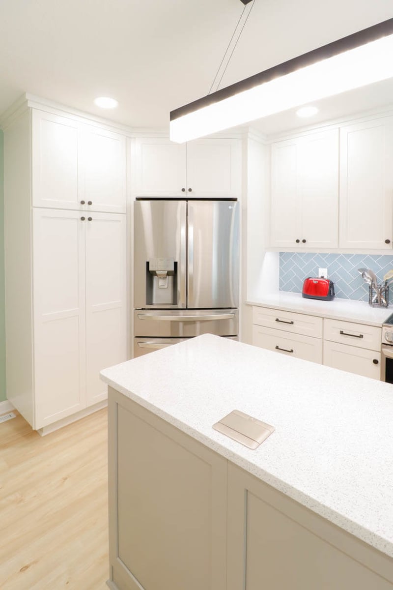 Emerald Lake, MI kitchen renovation by Odd Fellows Contracting featuring quartz countertops and stainless appliances