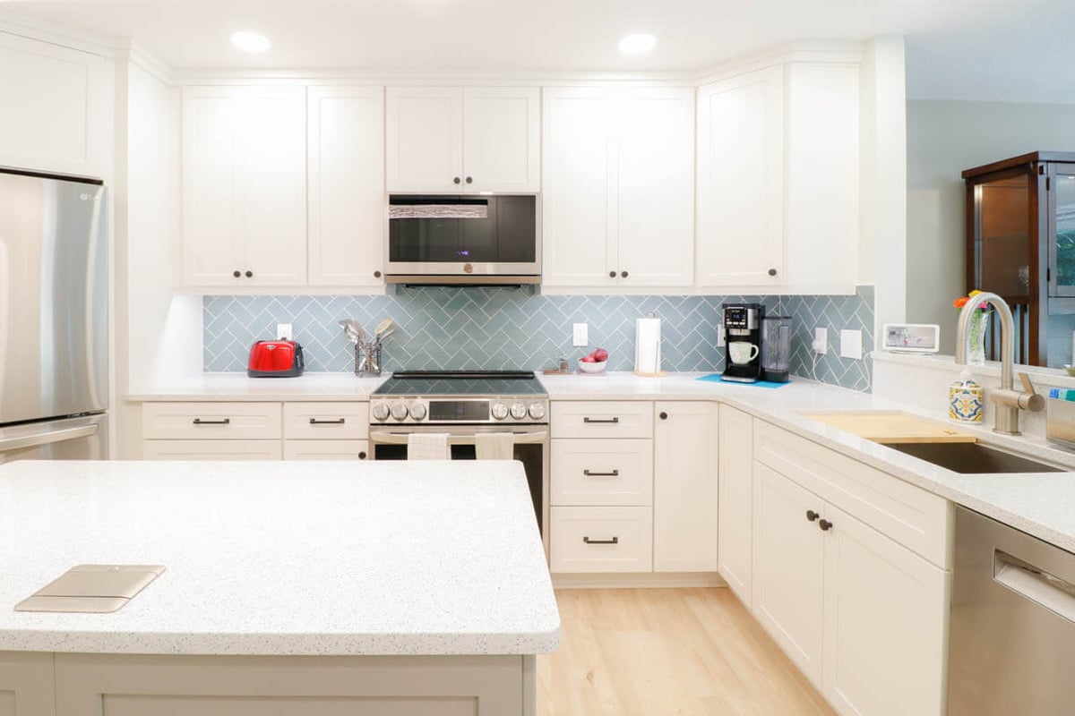 bright Emerald Lake, MI kitchen remodel by Odd Fellows Contracting showcasing white shaker cabinets
