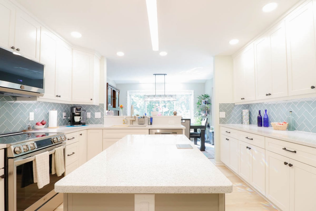 bright kitchen remodel by Odd Fellows Contracting in Emerald Lake, MI with large quartz island and recessed lighting