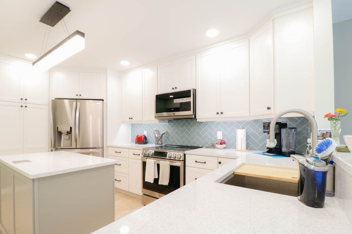 contemporary kitchen remodel by Odd Fellows Contracting in Emerald Lake, MI with stainless refrigerator and island