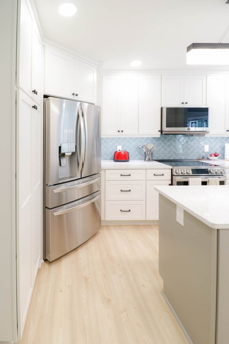 kitchen remodel by Odd Fellows Contracting in Emerald Lake, MI with stainless refrigerator and white shaker cabinets