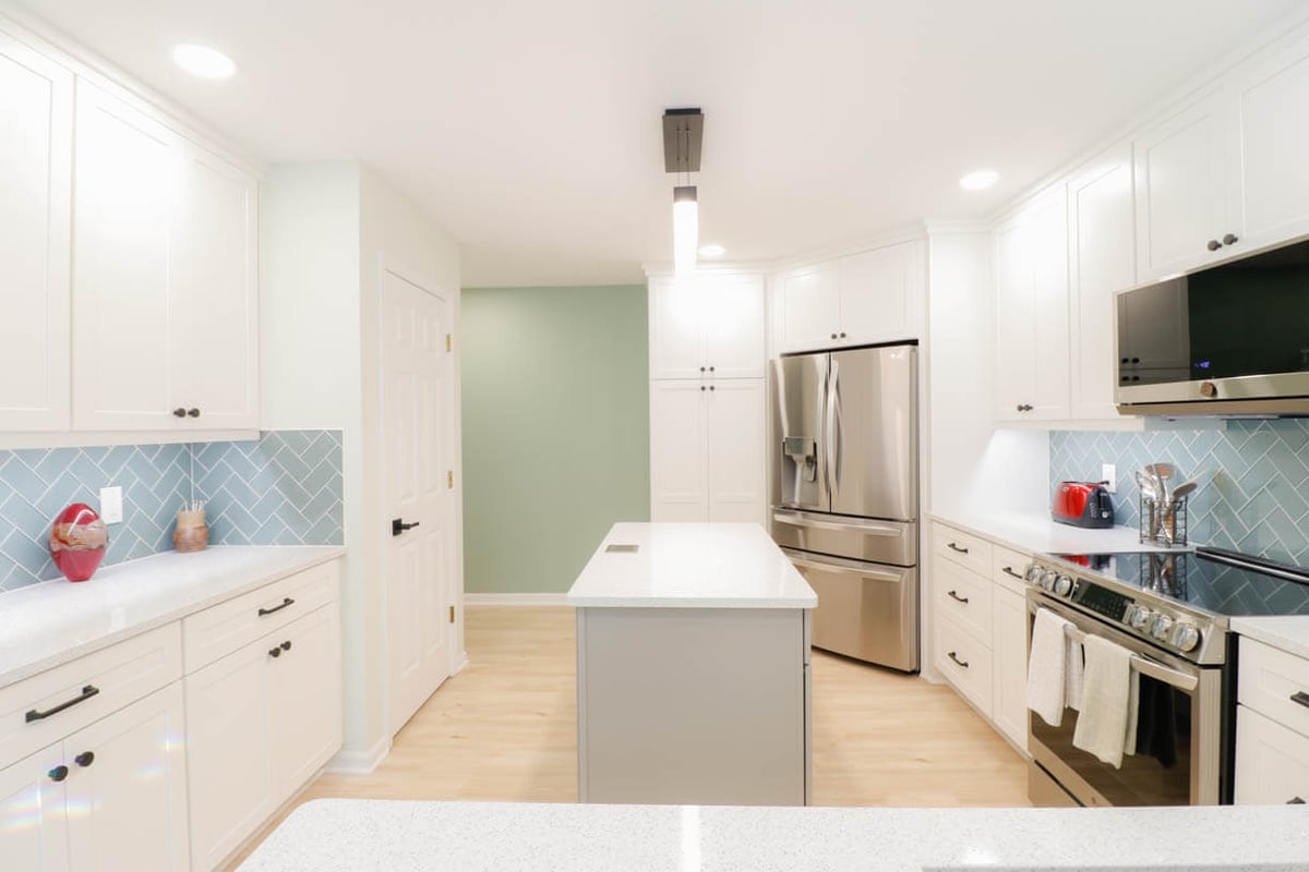 updated kitchen remodel by Odd Fellows Contracting in Emerald Lake, MI with custom cabinetry and tile backsplash