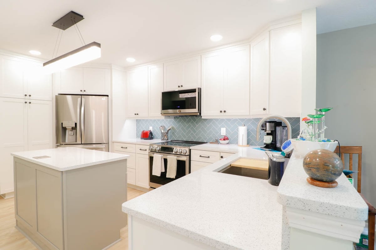 updated kitchen space by Odd Fellows Contracting in Emerald Lake, MI with recessed lighting and island