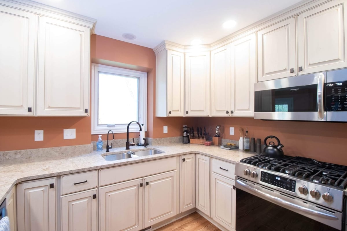 kitchen renovation featuring modern cabinetry and sink under window by Odd Fellows Contracting in Williamston MI