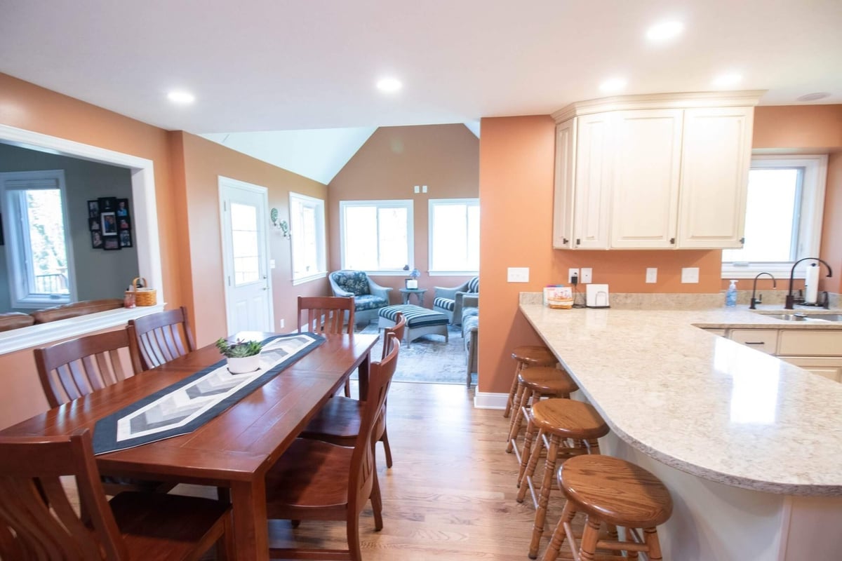 remodeled kitchen with cream cabinets and stainless refrigerator by Odd Fellows Contracting in Williamston MI