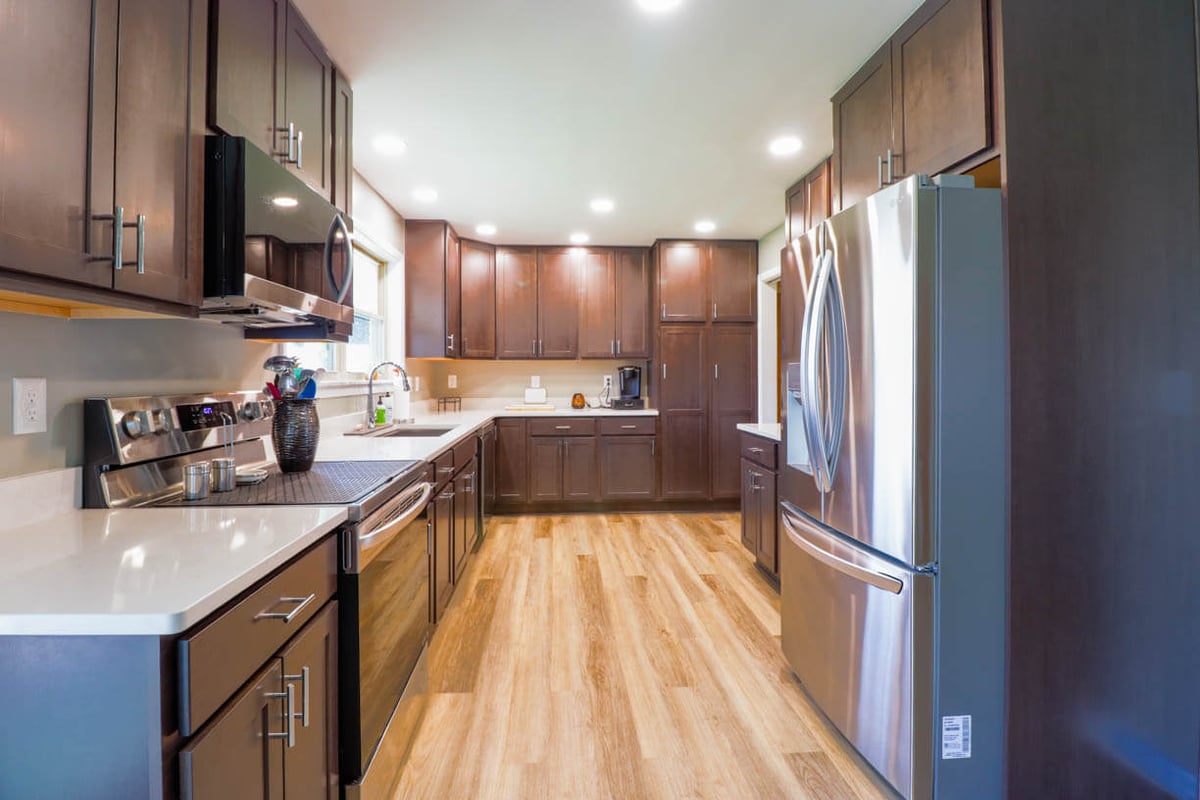 St. Joe, MI kitchen renovation showcasing stainless appliances and custom cabinets by Odd Fellows Contracting.
