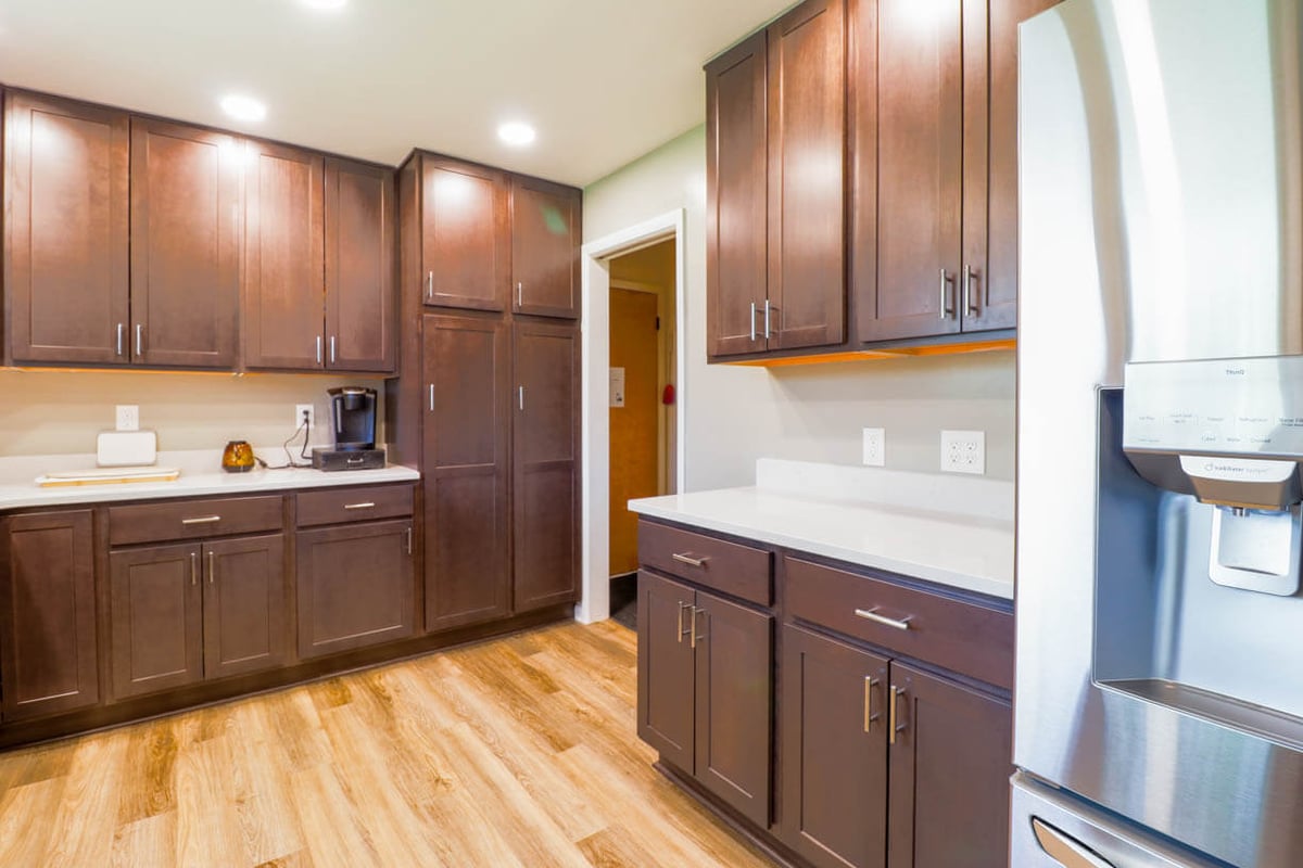 Updated kitchen space in St. Joe, MI remodeled by Odd Fellows Contracting with modern cabinetry and lighting.