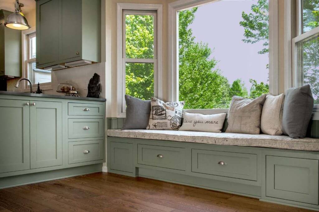 Built in window bench seating with storage in Williamston MI kitchen remodel by Odd Fellows Contracting