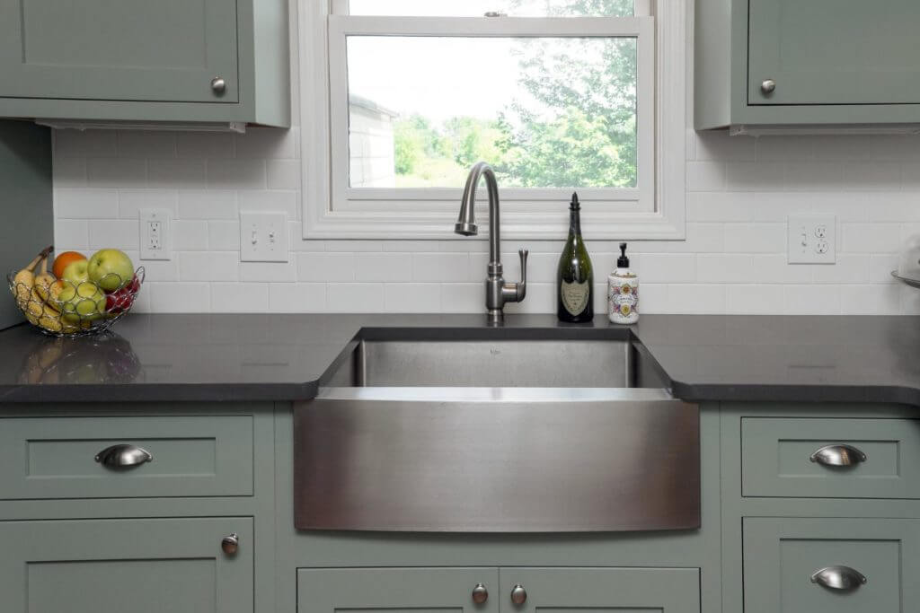 Stainless apron front sink installed during Williamston MI kitchen renovation by Odd Fellows Contracting