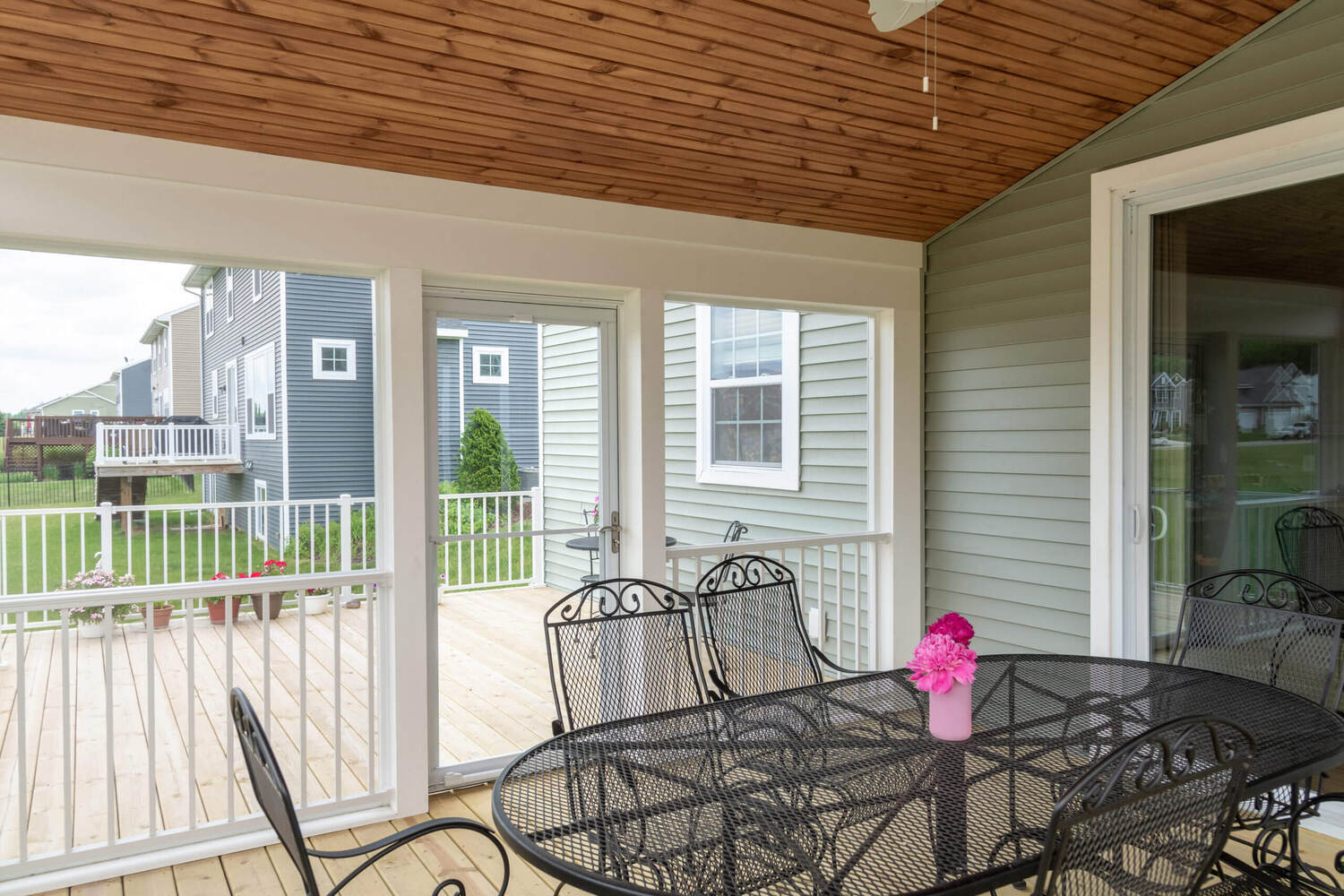 three season room interior with sliding door access to deck by Odd Fellows Contracting in Lansing MI