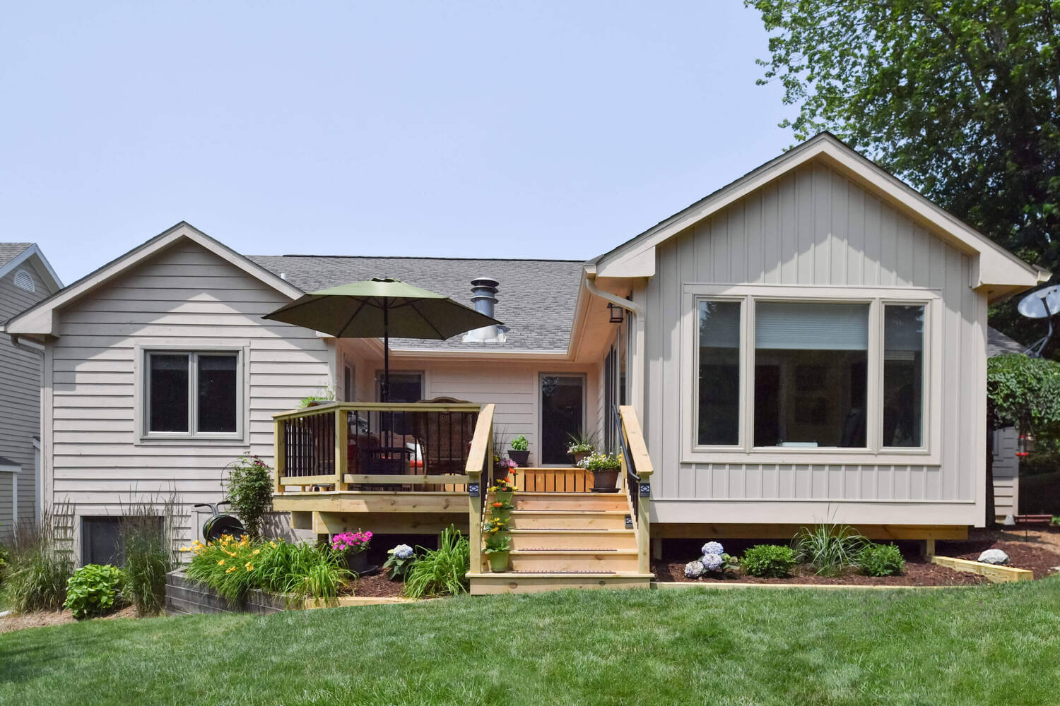 backyard deck and sunroom addition with stairs by Odd Fellows Contracting in Okemos, MI