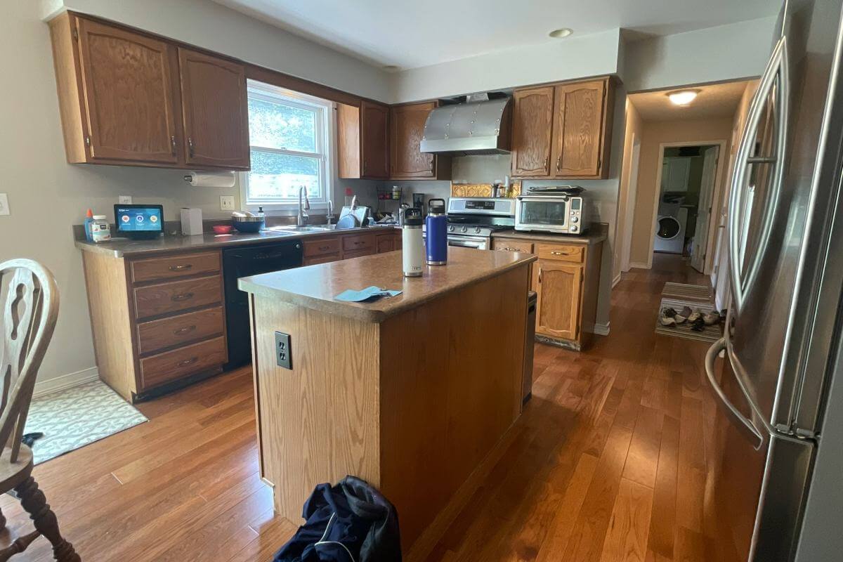 Cornell Woods, MI custom home build featuring modern kitchen with quartz countertops and wood cabinets by Odd Fellows Contracting.