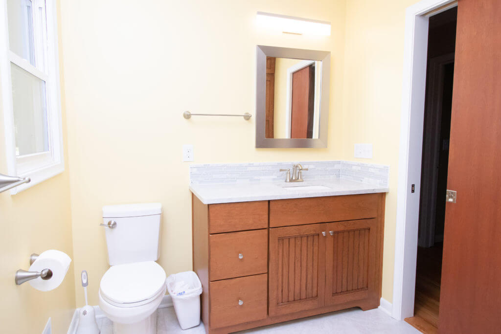 bathroom remodel featuring custom vanity cabinet and modern sink by Odd Fellows Contracting in Grand Ledge, MI