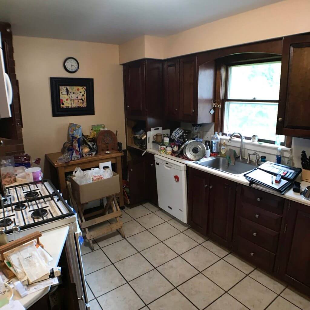 original kitchen before remodel with dark wood cabinets and tile flooring by Odd Fellows Contracting in Grand Ledge, MI