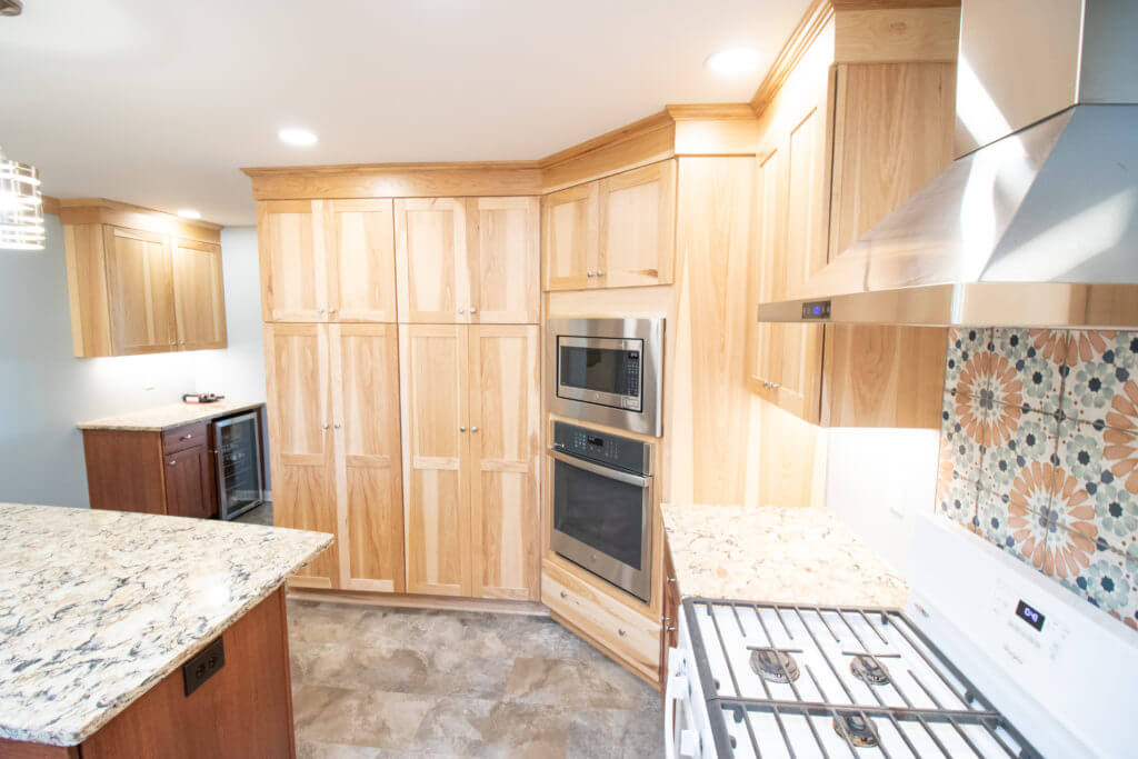 updated kitchen interior with granite countertops and spacious island workspace by Odd Fellows Contracting in Grand Ledge, MI