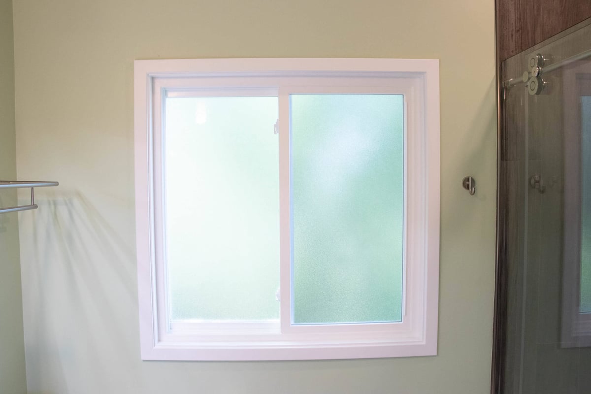 bathroom window by Odd Fellows Contracting in Williamston MI with frosted glass and natural light