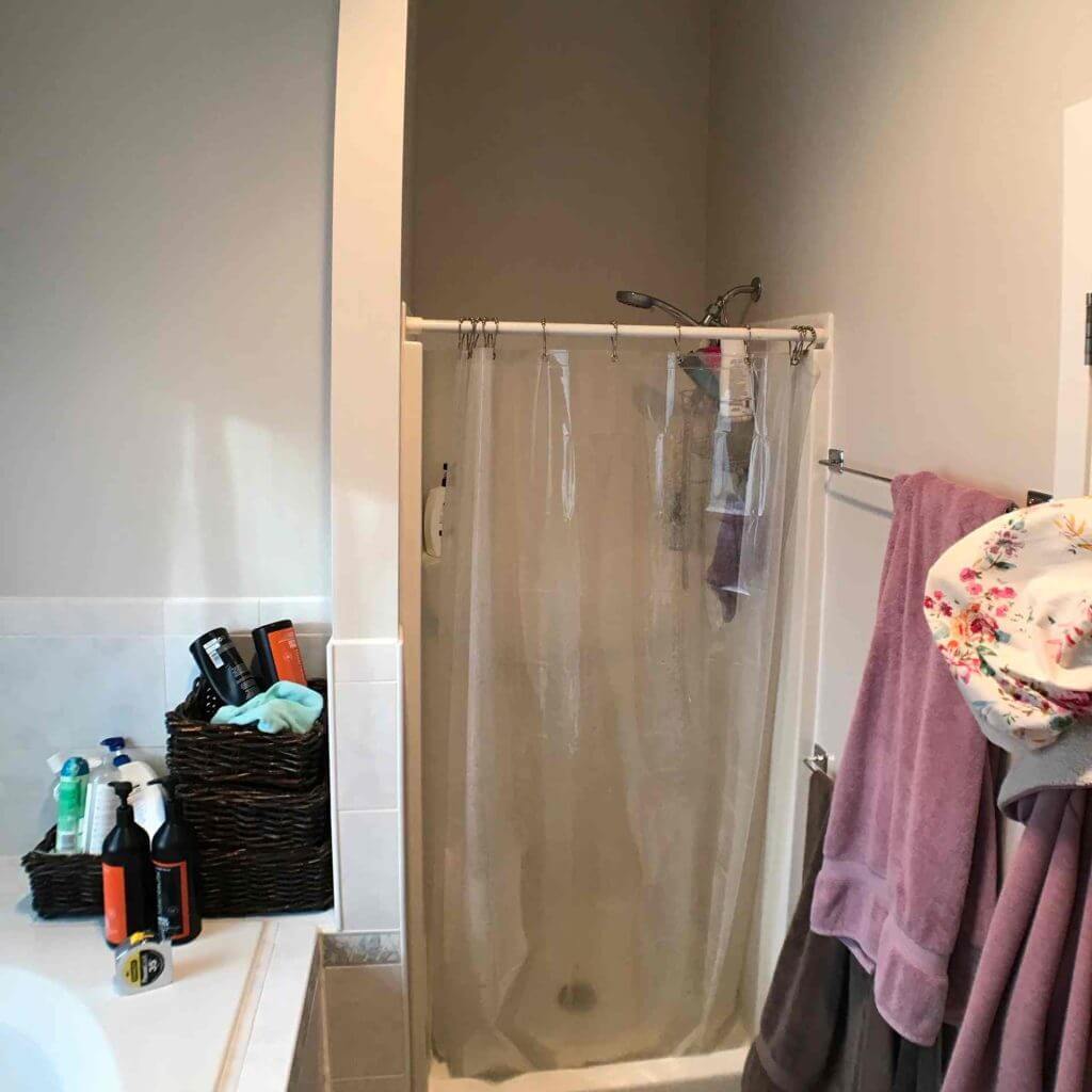 pre-remodel bathroom by Odd Fellows Contracting in Williamston MI showing shower curtain enclosure