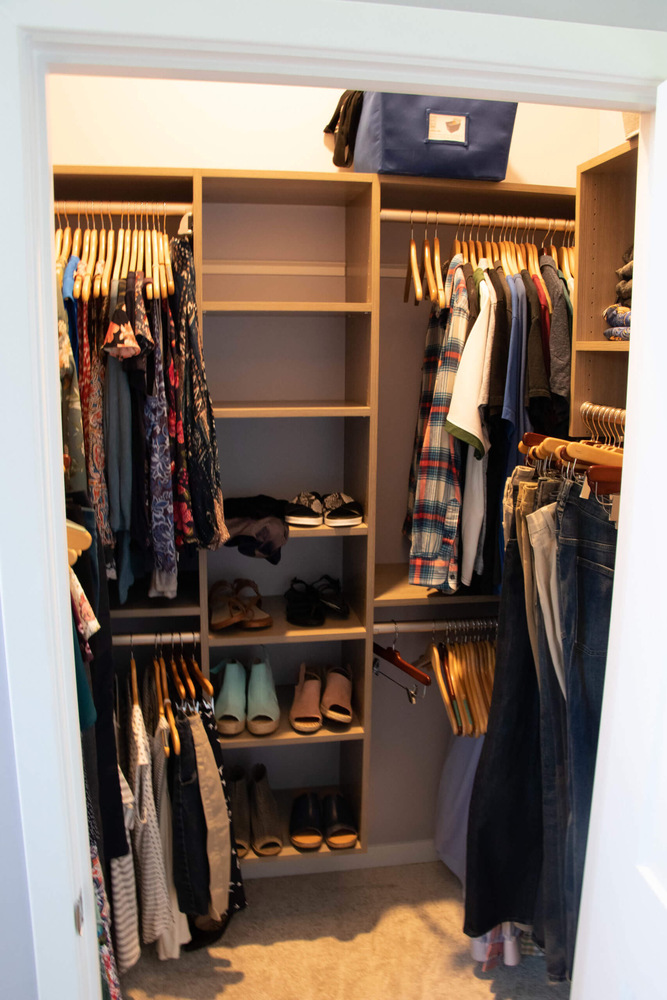 walk-in closet by Odd Fellows Contracting in Williamston MI with custom shelving and hanging storage