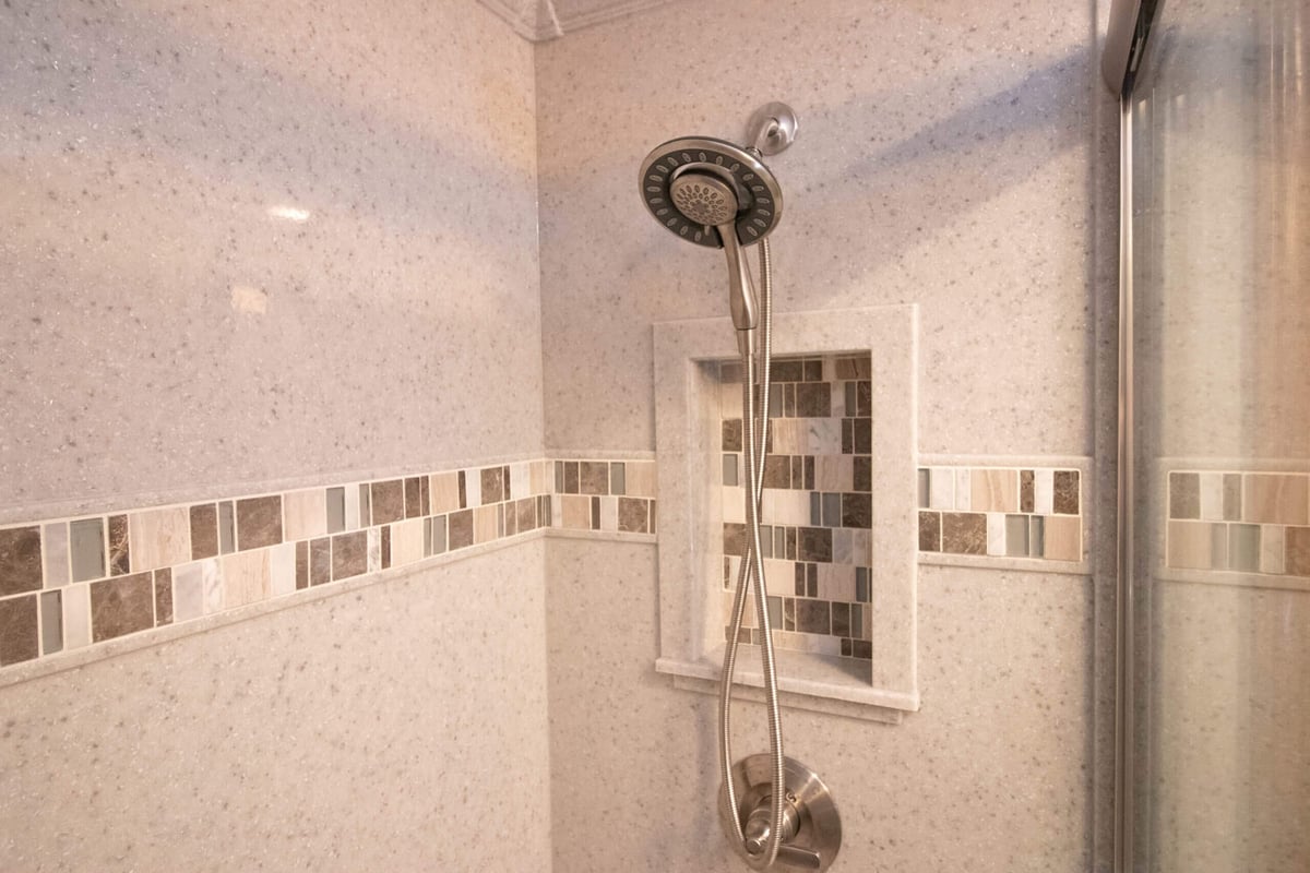 custom shower remodel by Odd Fellows Contracting in Mason MI with tile accent niche and modern fixtures
