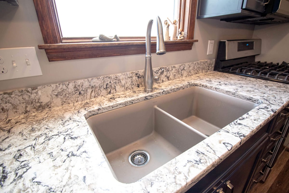 kitchen sink and countertop remodel by Odd Fellows Contracting in Mason MI with modern faucet and backsplash