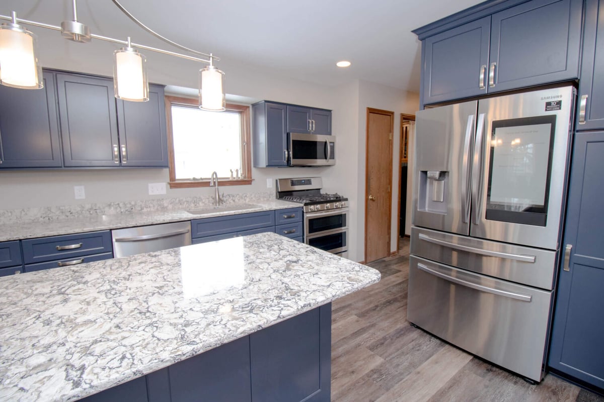 modern kitchen renovation by Odd Fellows Contracting in Mason MI featuring quartz island and updated cabinetry