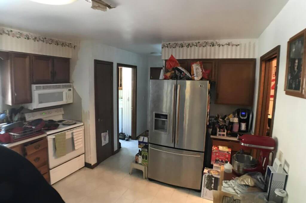 outdated kitchen before remodel by Odd Fellows Contracting in Mason MI showing original cabinets and appliances