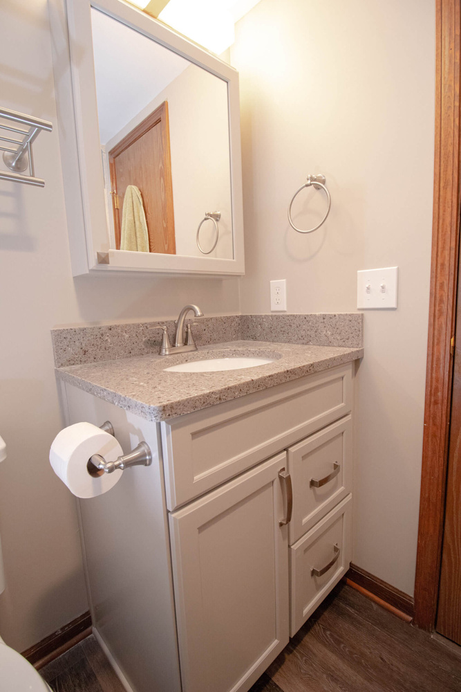 updated bathroom vanity by Odd Fellows Contracting in Mason MI with modern sink and storage cabinet