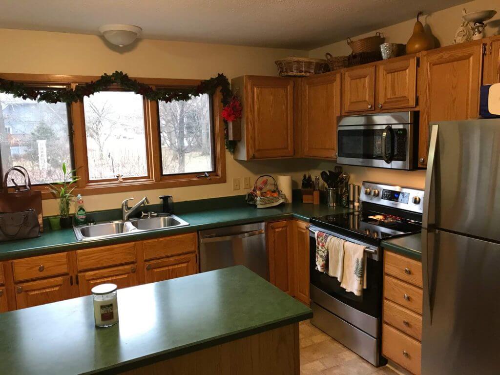 Original kitchen layout with wood cabinets and laminate countertops before remodel by Odd Fellows Contracting in Okemos, MI