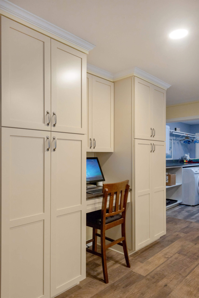 laundry room remodel with countertop workspace and storage cabinetry by Odd Fellows Contracting in Lansing, MI