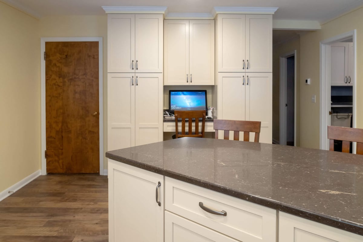remodeled kitchen with built-in desk area and tall shaker cabinets by Odd Fellows Contracting in Lansing, MI