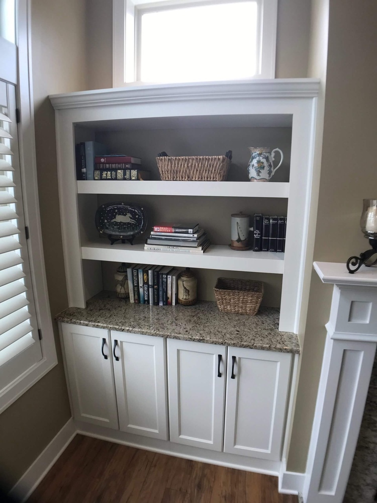 family room built in shelving unit with lower cabinets by Odd Fellows Contracting in Holt, MI