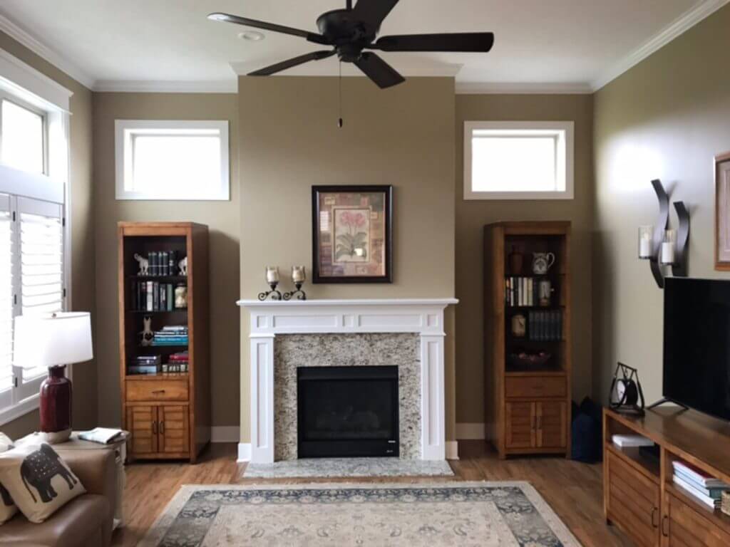 original living room fireplace wall before built in remodel by Odd Fellows Contracting in Holt, MI
