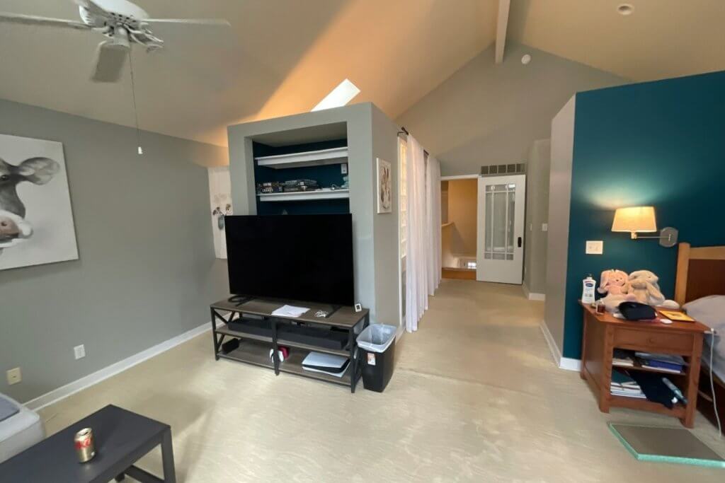custom home bedroom renovation by Odd Fellows Contracting in Lansing, MI featuring accent wall and TV nook