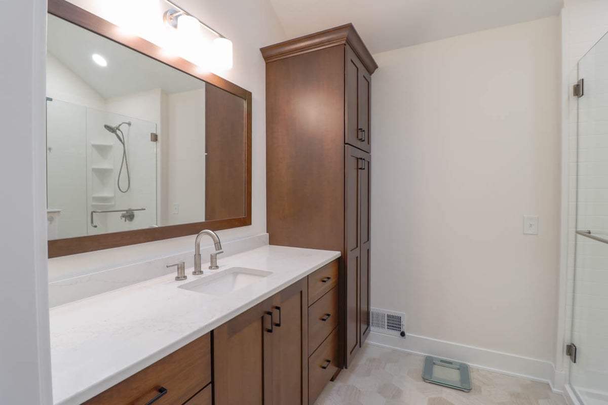 custom home primary bathroom by Odd Fellows Contracting in Lansing, MI with modern fixtures and tile floor
