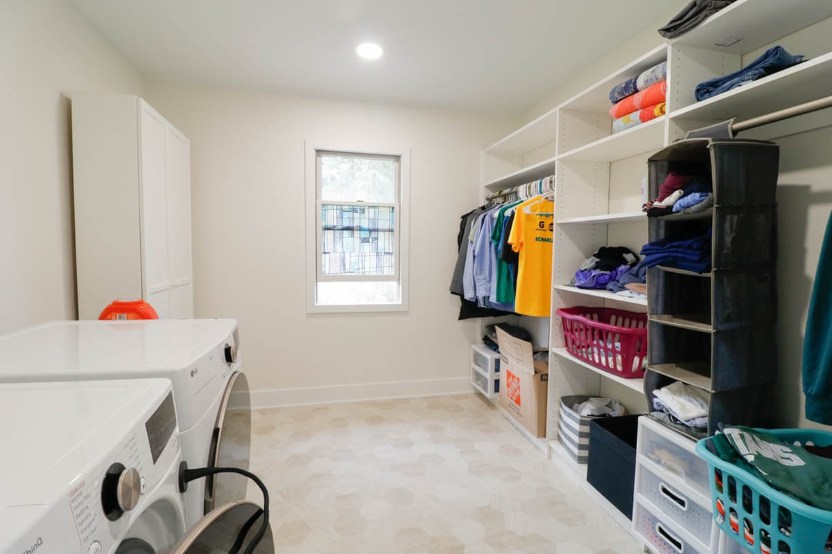 custom home utility room by Odd Fellows Contracting in Lansing, MI with cabinetry and clothing storage